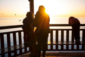 family in lakeside gazebo